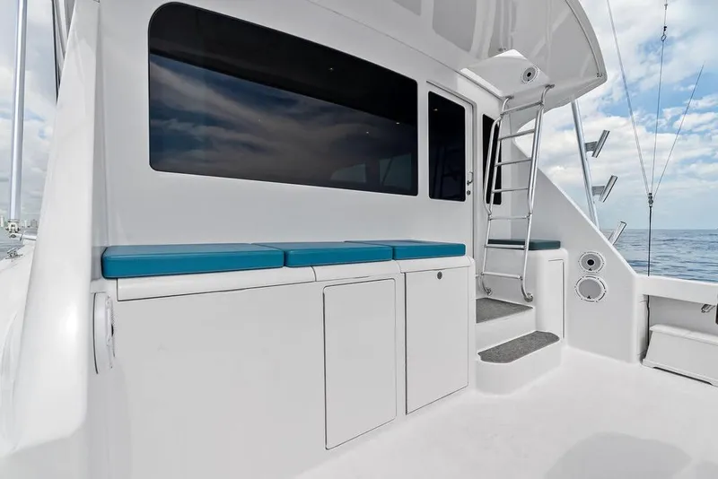 Slide: The Image of 2005 Viking 61 Convertible yacht deck with seating and ladder, ocean view. - 69