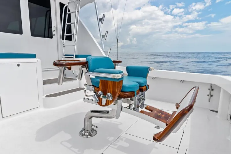 Slide: The Image of 2005 Viking 61 Convertible yacht deck with blue fishing chair, ocean view. - 70