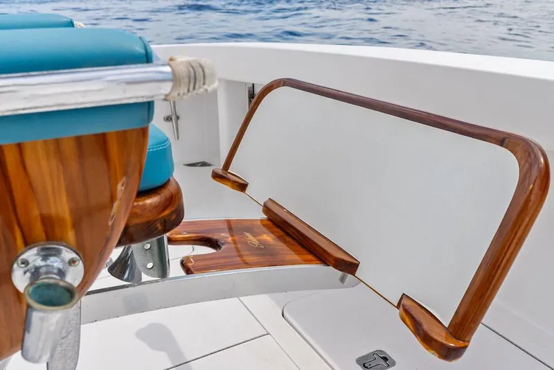 Slide: The Image of Luxury seating detail on 2005 Viking 61 Convertible yacht, featuring wood and teal upholstery. - 71