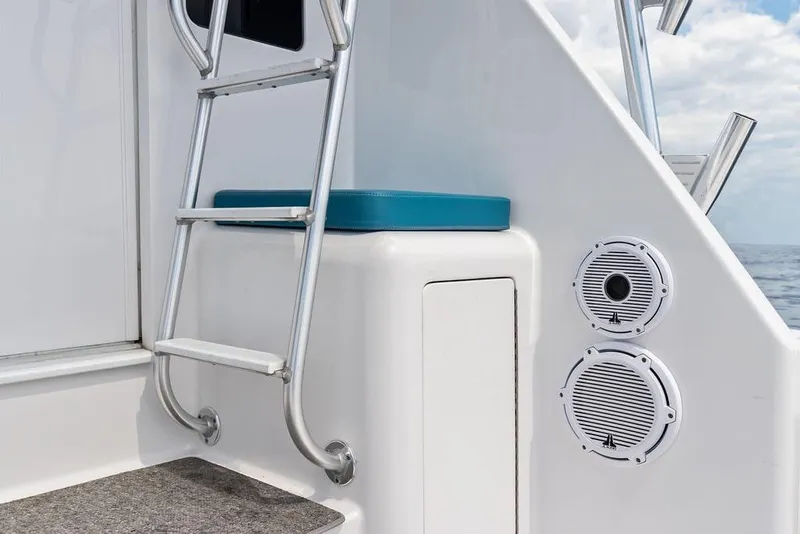 Slide: The Image of 2005 Viking 61 Convertible yacht ladder and speakers on deck, ocean view. - 73