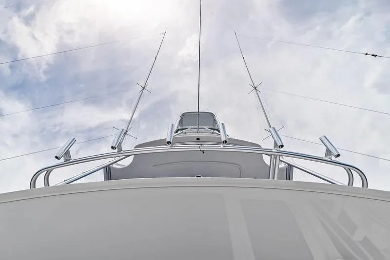 Slide: The Image of 2005 Viking 61 Convertible yacht, viewed from below against a cloudy sky. - 75