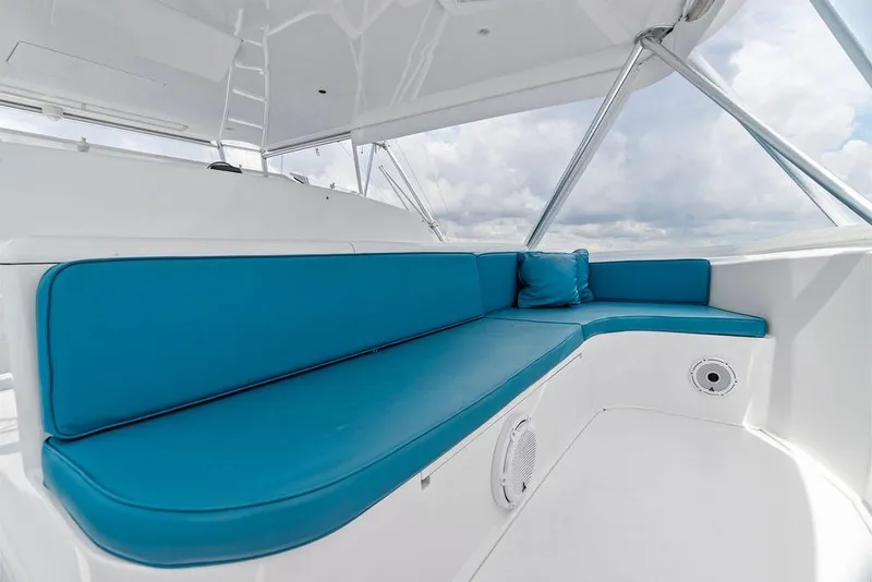 Slide: The Image of Luxurious seating area on a 2005 Viking 61 Convertible yacht with blue cushions. - 76