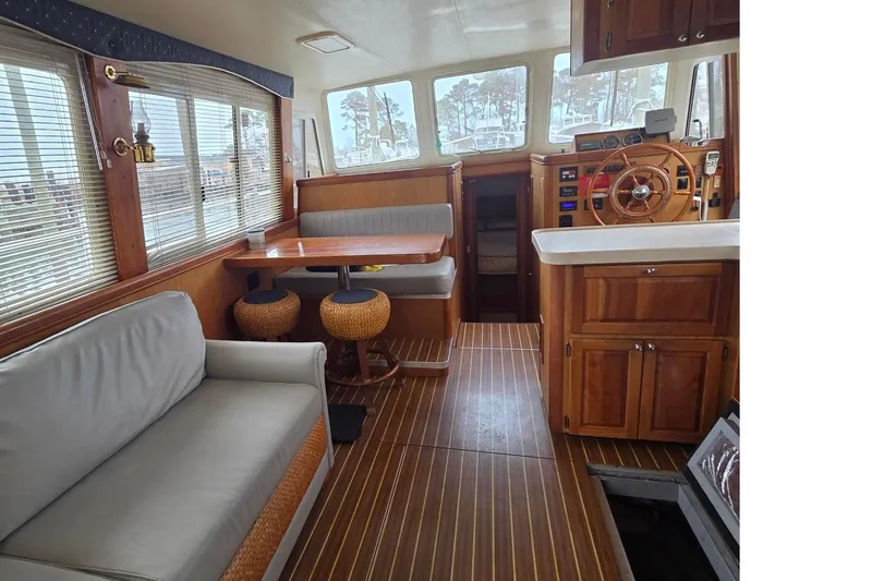 Slide: The Image of Interior of 2006 Mainship 40 Trawler with wood accents and comfortable seating. - 11