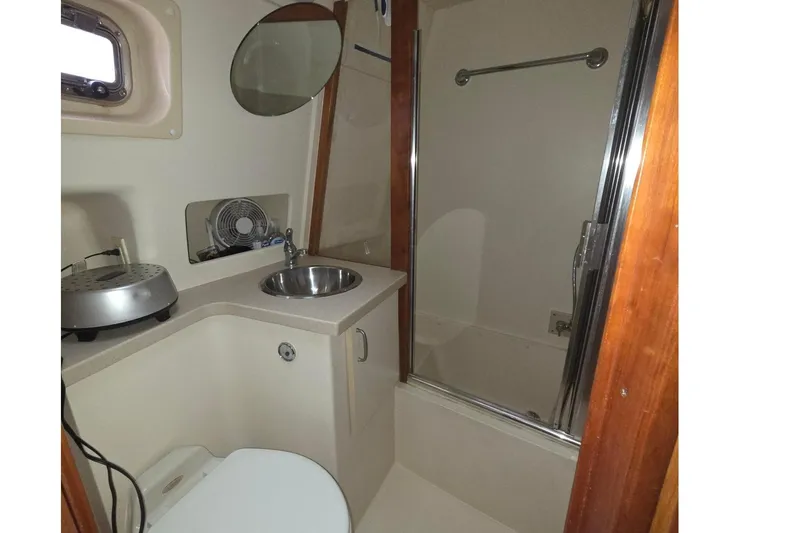 Slide: The Image of Bathroom interior of 2006 Mainship 40 Trawler with shower, sink, and toilet. - 13