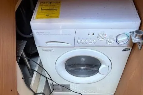 Slide: The Image of Washing machine inside 2006 Mainship 40 Trawler boat, compact laundry solution. - 16