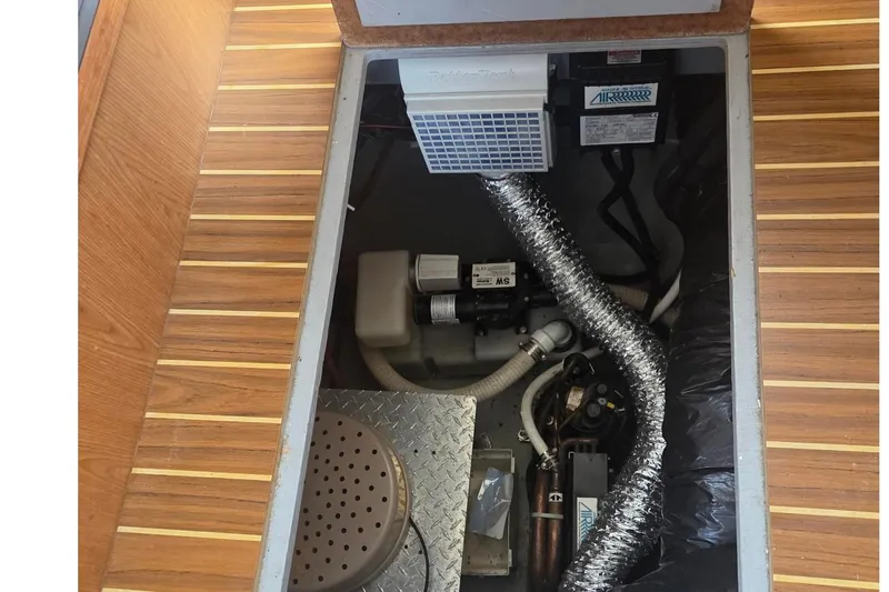 Slide: The Image of Engine compartment of a 2006 Mainship 40 Trawler with visible mechanical components. - 23