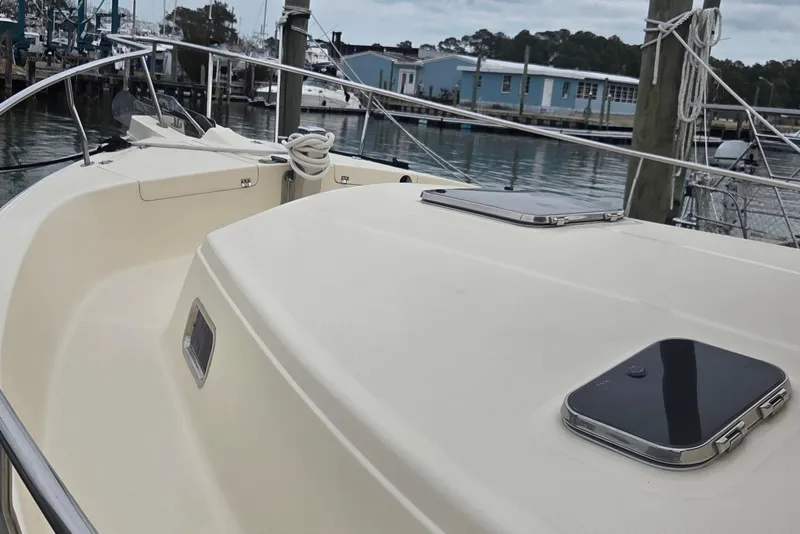 Slide: The Image of 2006 Mainship 40 Trawler docked, showcasing deck and hatch details. - 3