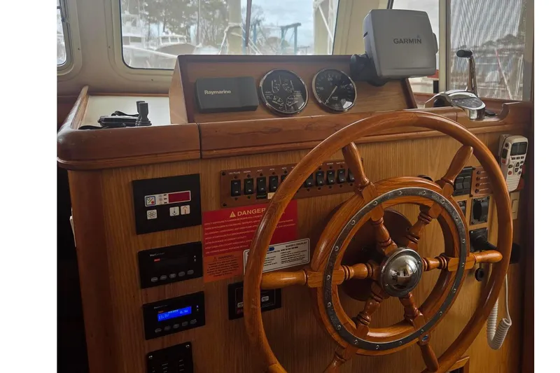 Slide: The Image of Wooden helm of 2006 Mainship 40 Trawler with navigation instruments and controls. - 6
