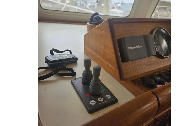 Slide: The Image of Control panel of 2006 Mainship 40 Trawler with Raymarine equipment and joystick controls. - 7