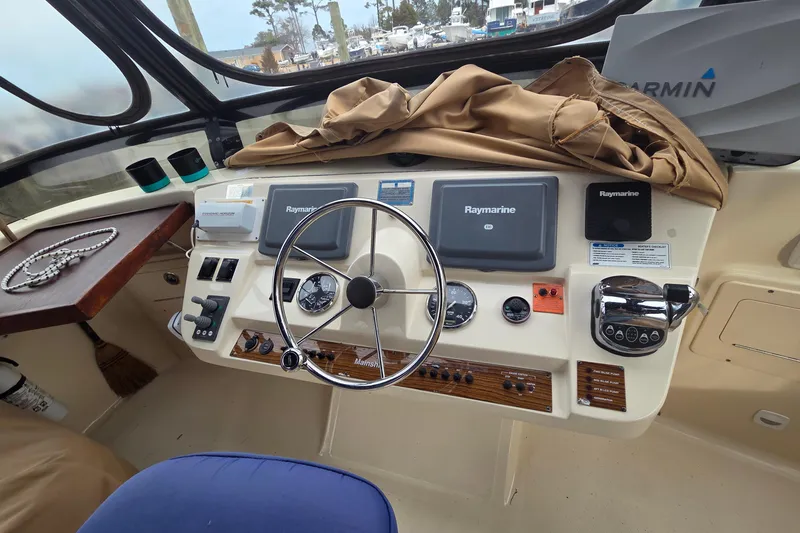 Slide: The Image of 2006 Mainship 40 Trawler helm with Raymarine electronics and steering wheel. - 8