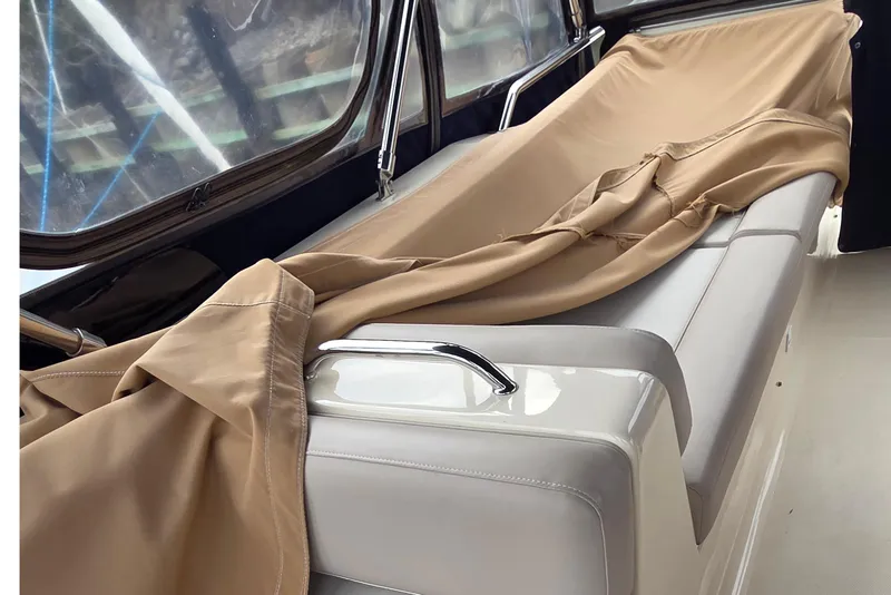 Slide: The Image of Interior of 2006 Mainship 40 Trawler with beige cover on seating area. - 9