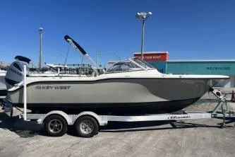 The Image of 2022 Key West 239 DFS boat on trailer, parked outdoors under clear blue sky. - 1