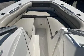Slide: The Image of 2022 Key West 239 DFS boat interior with cushioned seating and storage compartments. - 10