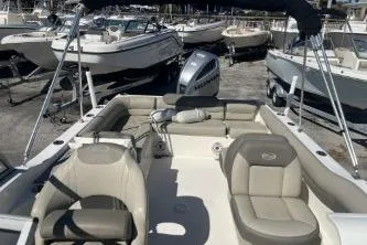 Slide: The Image of 2022 Key West 239 DFS boat with seating, docked among other boats. - 11