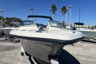 Slide: The Image of 2022 Key West 239 DFS boat displayed outdoors with clear blue sky and palm trees. - 3