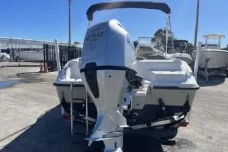 Slide: The Image of 2022 Key West 239 DFS boat with powerful outboard motor, parked in a marina. - 6