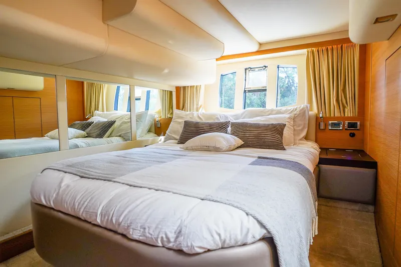 Slide: The Image of Luxurious bedroom interior of 2009 Fairline 48 Phantom yacht with elegant bedding and natural light. - 28