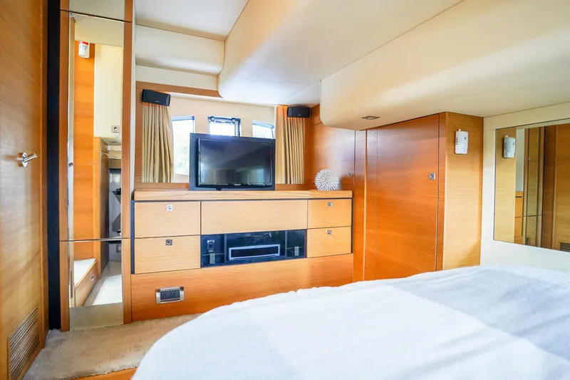 Slide: The Image of Luxurious interior of 2009 Fairline 48 Phantom yacht with modern wood finish and TV. - 29