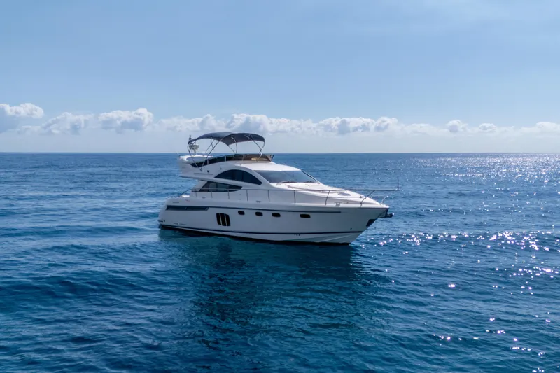 Slide: The Image of 2009 Fairline 48 Phantom yacht cruising on open sea under clear sky. - 3