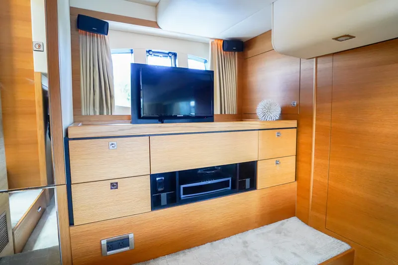 Slide: The Image of Luxurious interior of 2009 Fairline 48 Phantom yacht with modern wood cabinetry and TV. - 30