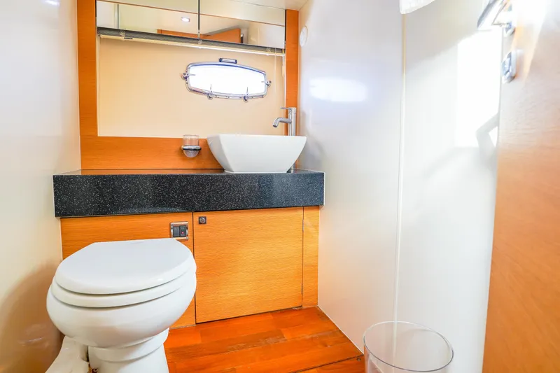 Slide: The Image of Luxurious bathroom in 2009 Fairline 48 Phantom yacht with modern fixtures and wood accents. - 32