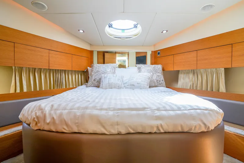 Slide: The Image of Luxurious bedroom interior of 2009 Fairline 48 Phantom yacht with elegant wood finishes. - 33
