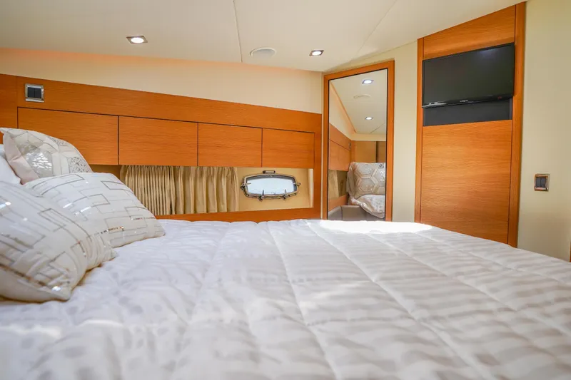 Slide: The Image of Luxurious bedroom interior of 2009 Fairline 48 Phantom yacht with modern wood finishes. - 34