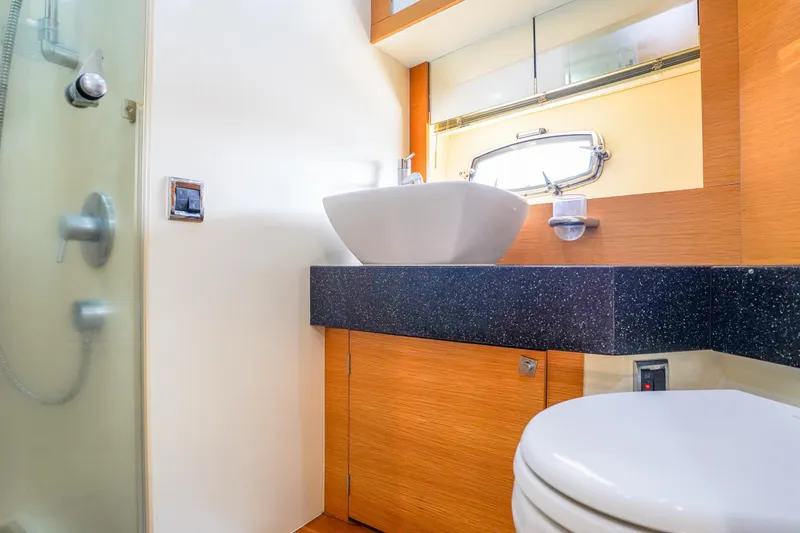 Slide: The Image of Luxurious bathroom in 2009 Fairline 48 Phantom yacht with modern fixtures and wood accents. - 37
