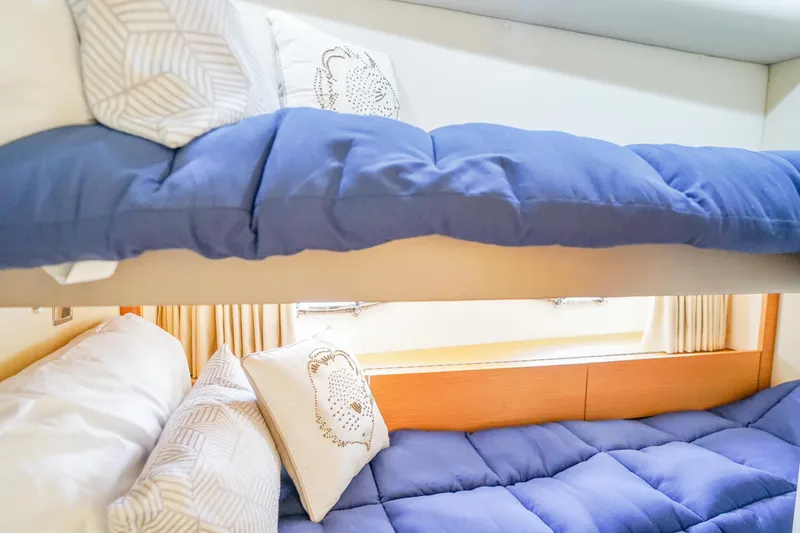 Slide: The Image of Bunk beds with blue bedding in 2009 Fairline 48 Phantom yacht cabin. - 38