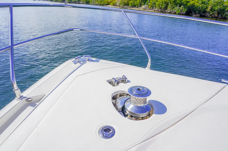 Slide: The Image of Bow of 2009 Fairline 48 Phantom yacht with anchor winch, surrounded by calm water. - 41
