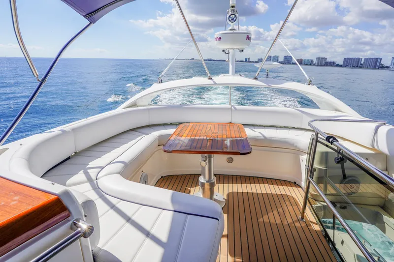 Slide: The Image of Luxurious 2009 Fairline 48 Phantom yacht cruising on open water, featuring elegant seating and table. - 46