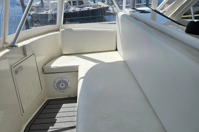 Slide: The Image of 1998 Ocean Yachts 40 Super Sport interior with white seating and marine speaker. - 10