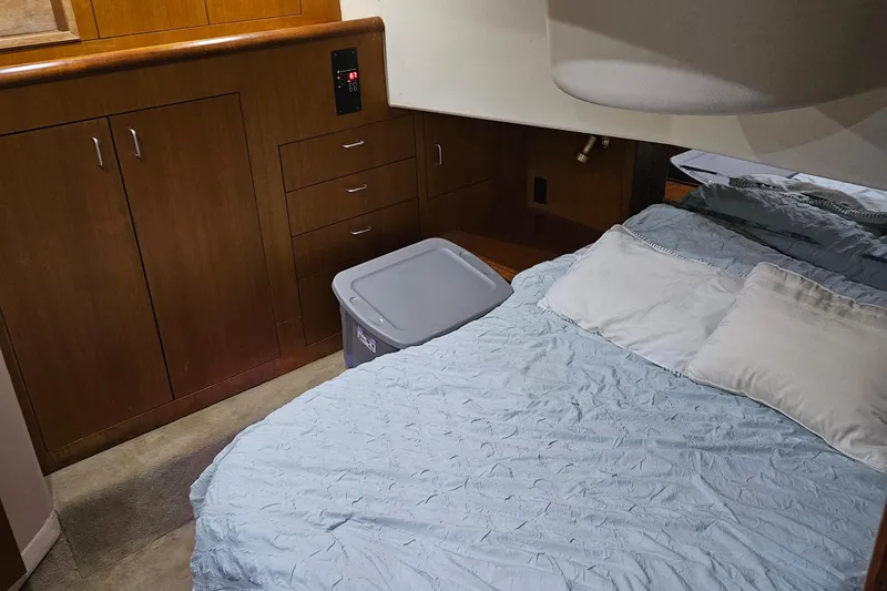 Slide: The Image of Cozy cabin interior of 1998 Ocean Yachts 40 Super Sport with bed and wooden cabinetry. - 18