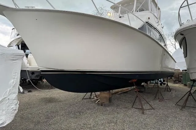 Slide: The Image of 1998 Ocean Yachts 40 Super Sport on stands, side view, in a boatyard. - 2