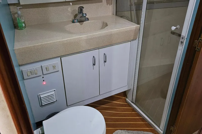Slide: The Image of Bathroom interior of 1998 Ocean Yachts 40 Super Sport with sink, shower, and toilet. - 20