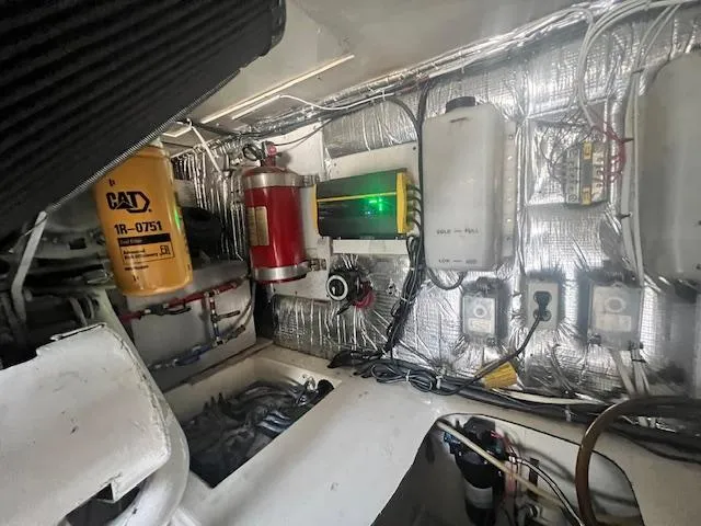 Slide: The Image of Engine room of 1998 Ocean Yachts 40 Super Sport with various mechanical components. - 25