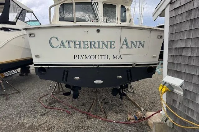 Slide: The Image of 1998 Ocean Yachts 40 Super Sport boat named "Catherine Ann" in Plymouth, MA, docked on land. - 4