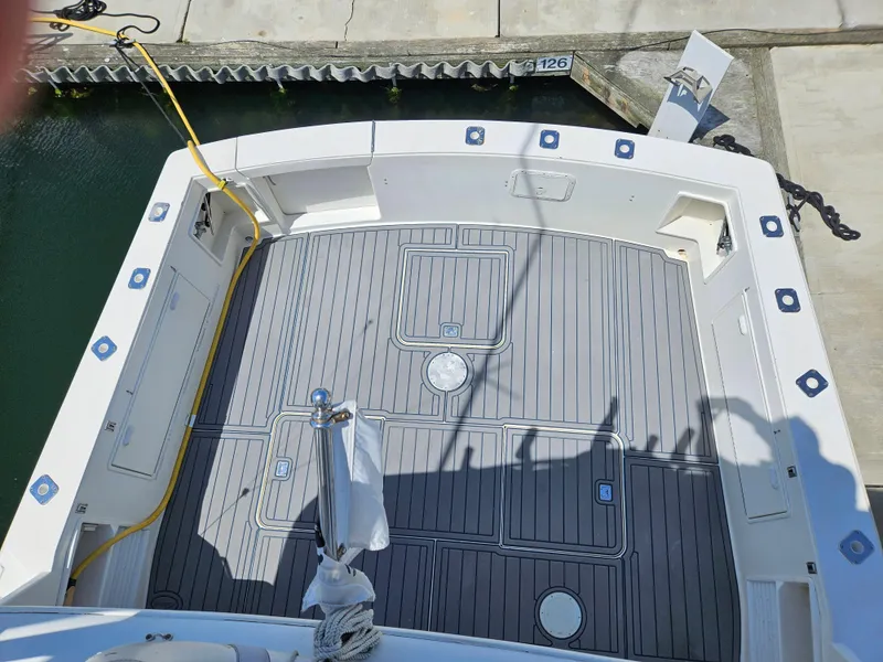 Slide: The Image of 1998 Ocean Yachts 40 Super Sport boat deck with gray flooring at a marina. - 7