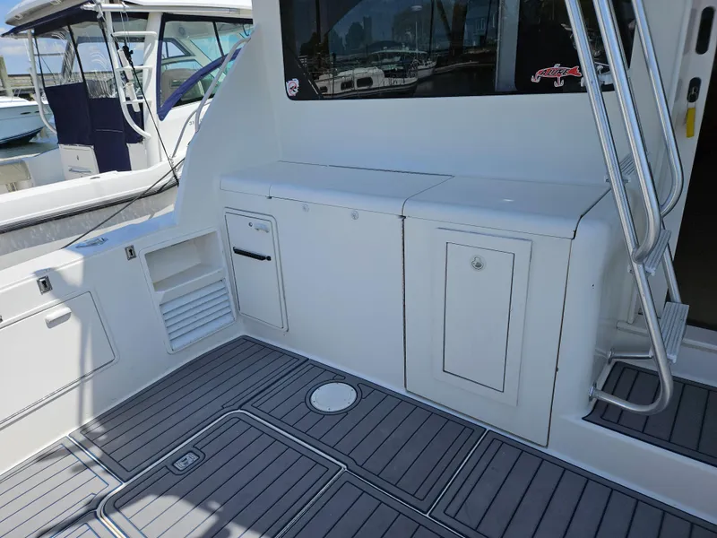 Slide: The Image of 1998 Ocean Yachts 40 Super Sport deck with storage compartments and sleek design. - 8