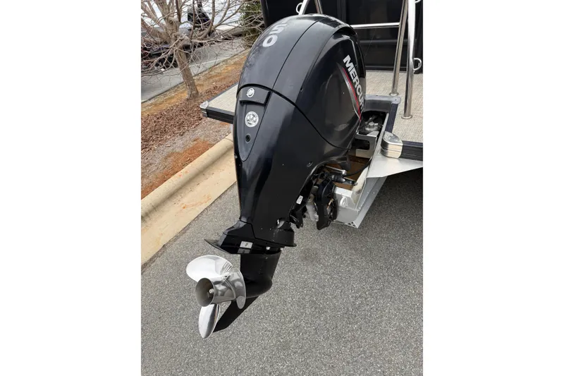 Slide: The Image of Outboard motor on a 2021 Barletta C22QC boat, parked on pavement. - 10