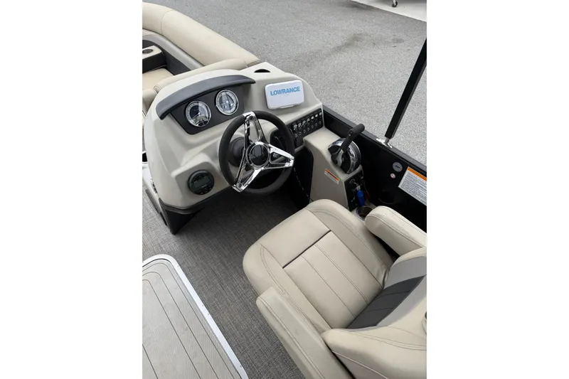 Slide: The Image of 2021 Barletta C22QC boat interior with steering wheel and control panel. - 14