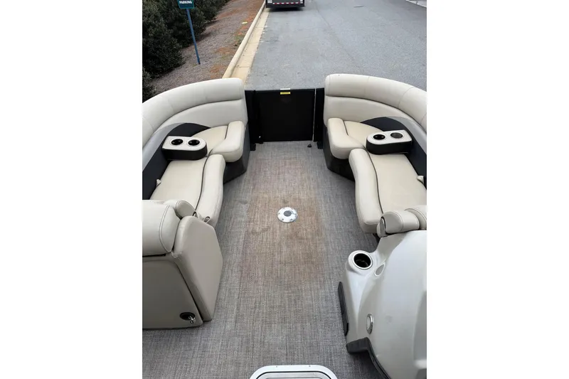 Slide: The Image of 2021 Barletta C22QC pontoon boat interior with beige seating and cup holders. - 17