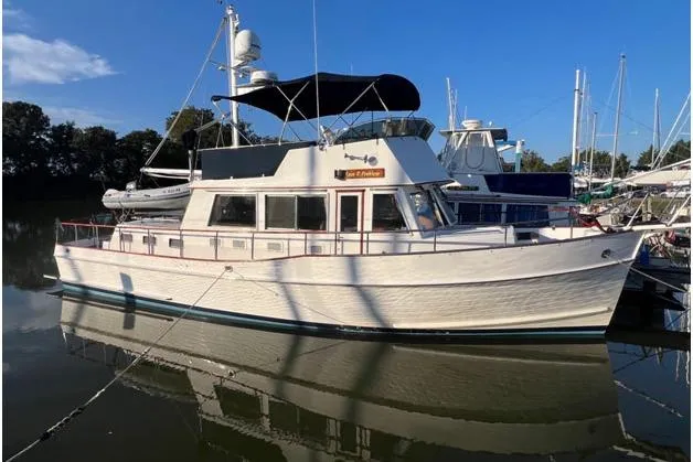 The Image of 2002 Grand Banks 42 Classic yacht docked in a marina under clear blue skies. - 0