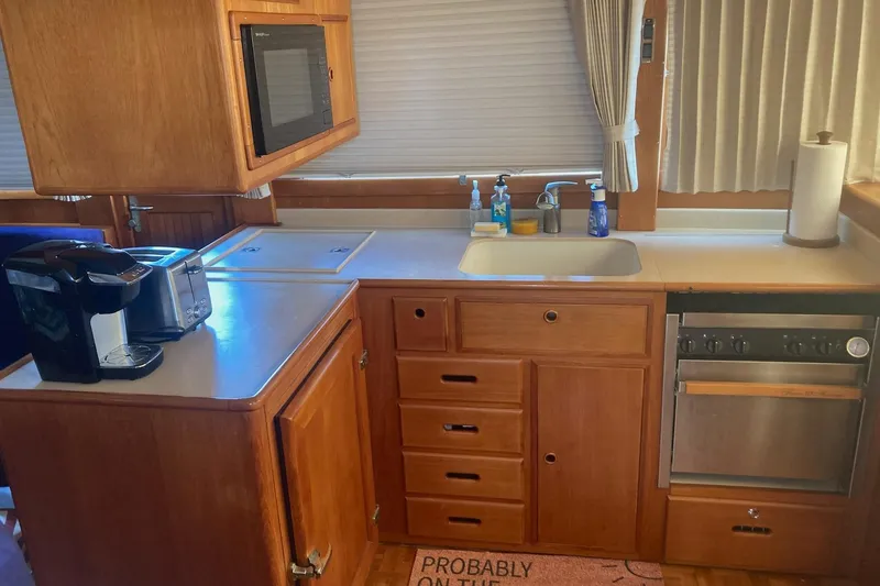 Slide: The Image of Galley kitchen in 2002 Grand Banks 42 Classic yacht with appliances and wooden cabinetry. - 10