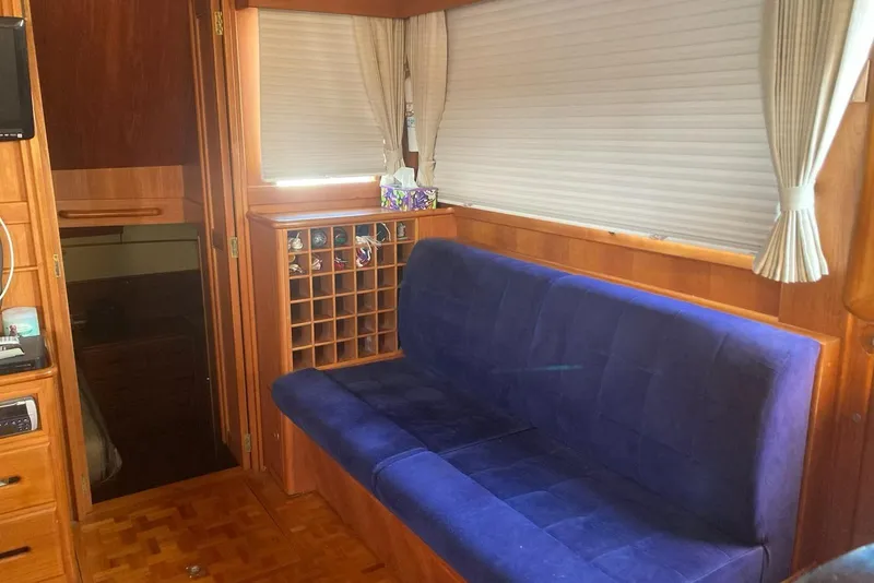 Slide: The Image of Interior of 2002 Grand Banks 42 Classic yacht with blue sofa and wooden cabinetry. - 12