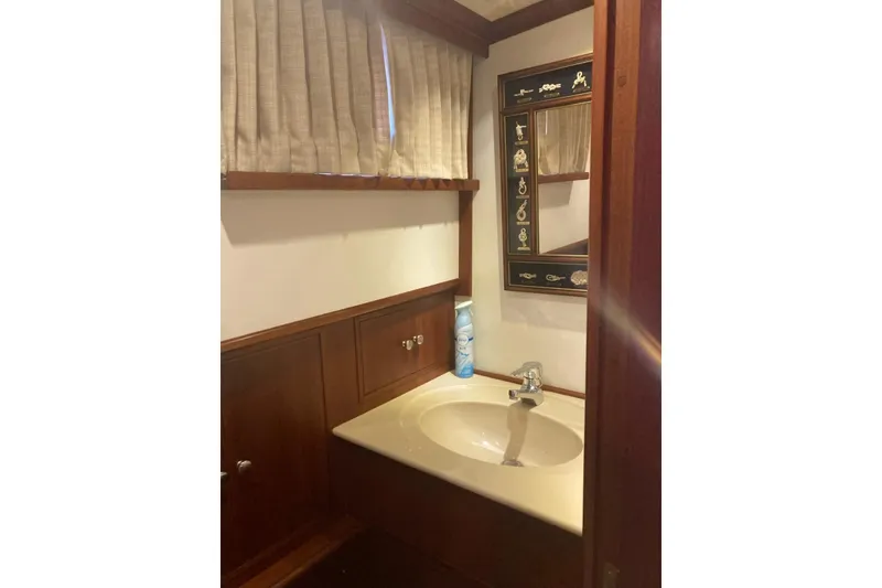 Slide: The Image of Bathroom interior of 2002 Grand Banks 42 Classic yacht with wooden cabinetry and decorative mirror. - 19