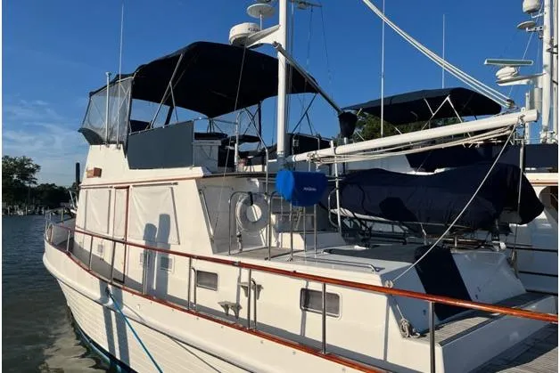 Slide: The Image of 2002 Grand Banks 42 Classic yacht docked under clear blue sky. - 2