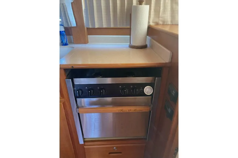 Slide: The Image of Galley kitchen in 2002 Grand Banks 42 Classic yacht with stove and paper towel holder. - 22