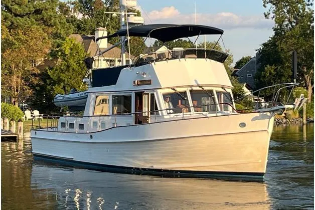 Slide: The Image of 2002 Grand Banks 42 Classic yacht cruising on a serene waterway. - 5