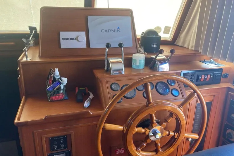 Slide: The Image of Helm of 2002 Grand Banks 42 Classic with wooden wheel and navigation equipment. - 9